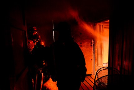502nd Civil Engineer Squadron firefighters start a training fire Nov. 17, 2015, at the Joint Base San Antonio-Fort Sam Houston burn building. Firefighters from JBSA-Randolph, Lackland, Fort Sam Houston and Bexar County combined to review basic firefighting techniques including ladder rescue, emergency medicine, search and rescue and how to quickly suppress and extinguish a house fire. (U.S. Air Force photo by Airman 1st Class Stormy Archer/Released)