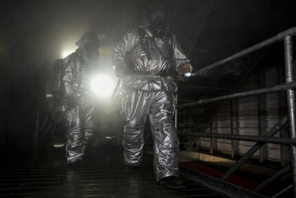 502nd Civil Engineer Squadron firefighters practice search and rescue techniques Nov. 17, 2015, at the Joint Base San Antonio-Fort Sam Houston burn building. Firefighters from JBSA-Randolph, Lackland, Fort Sam Houston and Bexar County combined to review basic firefighting techniques including ladder rescue, emergency medicine, search and rescue and how to quickly suppress and extinguish a house fire. (U.S. Air Force photo by Airman 1st Class Stormy Archer/Released)
