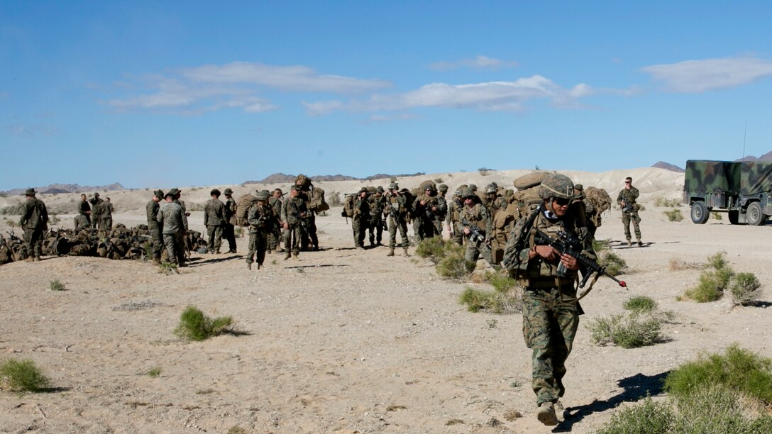 Marines with Company F, 2nd Battalion, 7th Marine Regiment, act as the opposing forces for a movement-to-contact training mission, Exercise Watchtower, Nov. 9, 2015. The exercise provided the Marines an opportunity to better themselves securing areas and locating opposing forces, as well as enabling the leaders of the various teams with the ability to make crucial decisions in the fog of war.