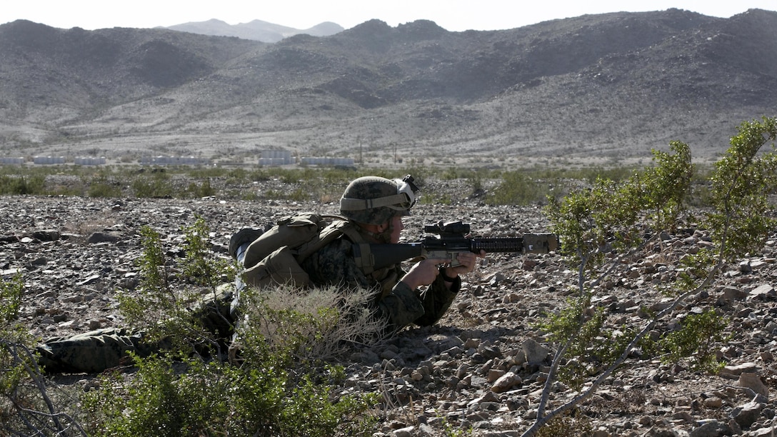 Pfc. Christopher Hatton, rifleman, Company F, 2nd Battalion, 7th Marine Regiment, provides security while acting as part of the opposing forces in a movement-to-contact training mission, Operation Watchtower, Nov. 10, 2015. The exercise provided the Marines an opportunity to better themselves securing areas and locating opposing forces, as well as enabling the leaders of the various teams with the ability to make crucial decisions in the fog of war.