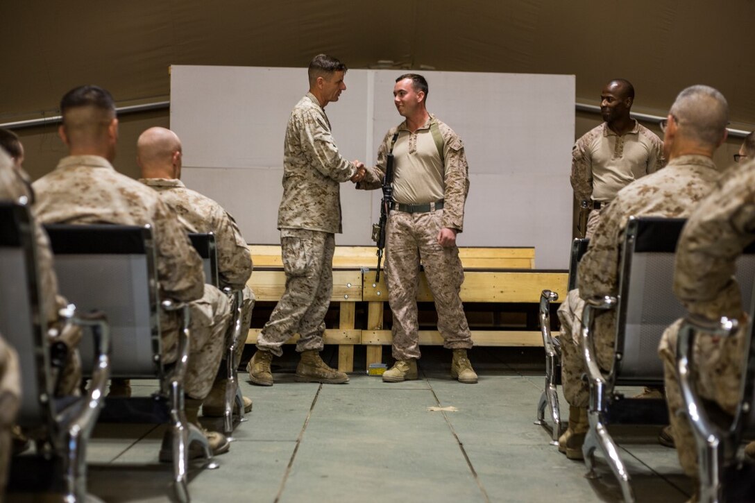 U.S. Marine Corps Lt. Gen. William D. Beydler, Marine Corps Forces Central Command (MARCENT) Commanding General, congratulates Lance Cpl. Clayton Degnan for his outstanding performance as a squad leader, with Company C, 7th Marine Regiment, Special Purpose Marine Air Ground Task Force - Crisis Response - Central Command (SPMAGTF-CR-CC) at an Undisclosed Location, Southwest Asia, Nov. 18, 2015.  SPMAGTF-CR-CC is deployed with a crisis response mission spanning 20 nations of U.S. Central Command. (U.S. Marine Corps photo by Lance Cpl. Clarence Leake/Released)