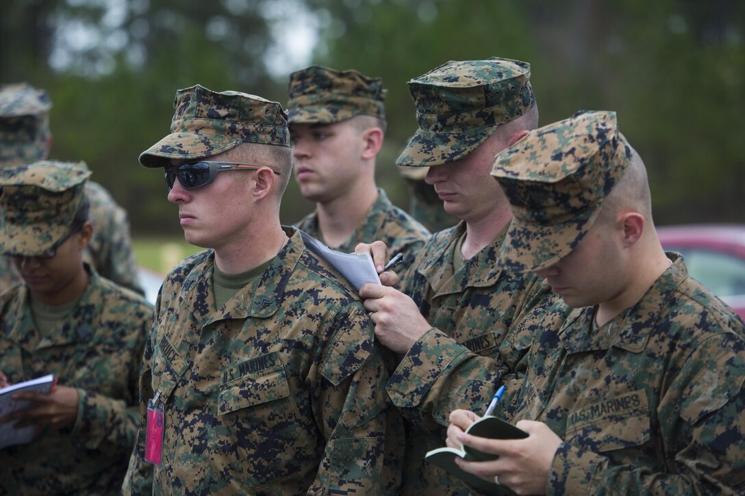 Chemical, biological, radiological and nuclear defense specialists from across Marine Forces Reserve take notes during a mission briefing at Camp Shelby, Miss., Nov. 17, 2015. The Marines conducted CBRN training scenarios as part of a week-long Advanced Consequence Management course held by MARFORRES. (U.S. Marine Corps photo by Cpl. Ian Leones/Released)