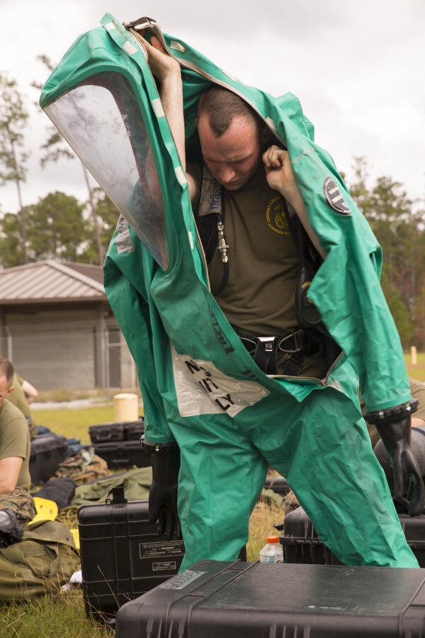 Lance Cpl. Jacob A. Golding, chemical, biological, radiological and nuclear defense specialist with CBRN platoon, Combat Logistics Regiment 4, puts on his level A suit before conducting CBRN training at Camp Shelby, Miss., Nov. 17, 2015. The level A suit provides the Marines with the highest level of protection from hazardous materials and is commonly worn by firefighters. (U.S. Marine Corps photo by Cpl. Ian Leones/Released)