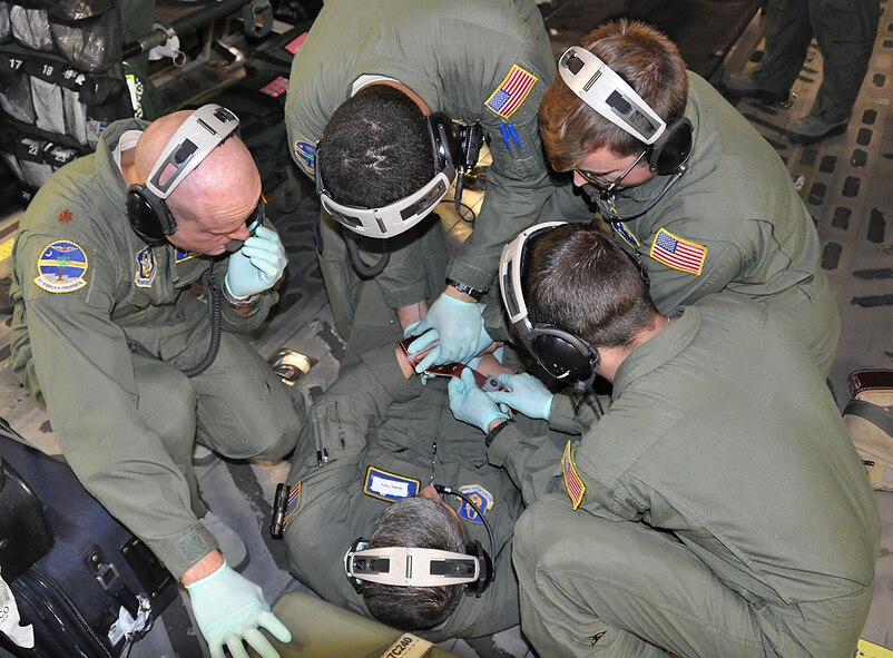 During an off station exercise for the 315th Aeromedical Evacuation Squadron. Master Sgt. Johnny Gomez played the part of a Soldier returning to Afghanistan after multiple deployments. This scenario was to gauge how the AE members would react when the Soldier had an anxiety attack midair and eventually became combative. The patient was successfully restrained to keep him from harming himself or others on the jet. (U.S. Air Force Photo by 2nd Lt. Chris Long)