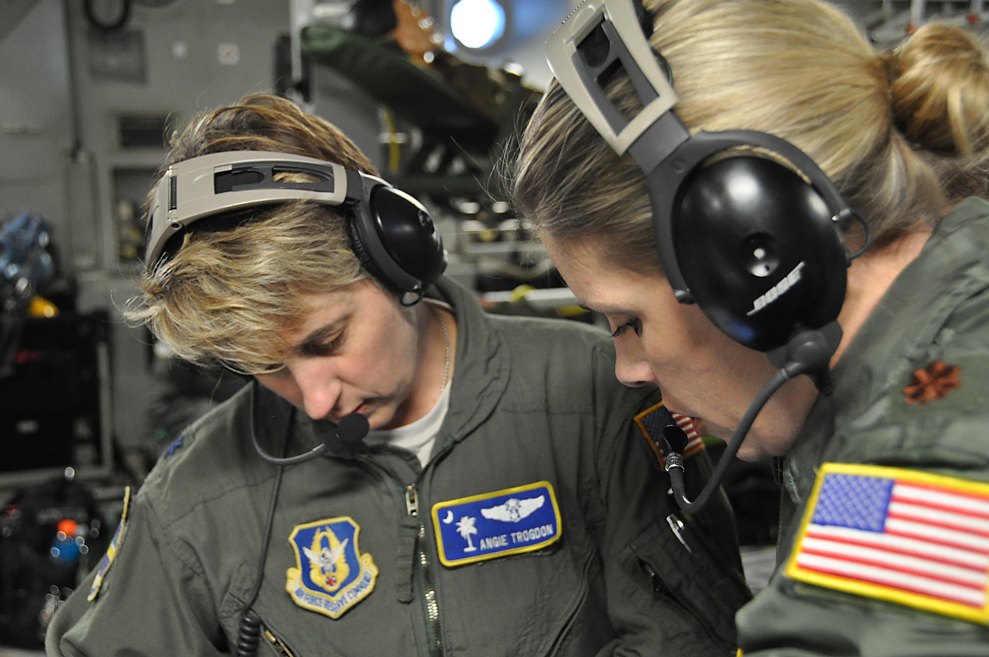 Lt Col Angie Trogdon, 315th Aeromedical Evacuation Squadron flight nurse and  officer in charge of operations, and Major Roseann Teckman, 315th AES examiner and Standardization and Evaluation team member, discuss task requirements for currency and check ride training during an off station exercise for the Aeromedical Evacuation Squadron in November.  (U.S. Air Force Photo by 2nd Lt. Chris Long)
