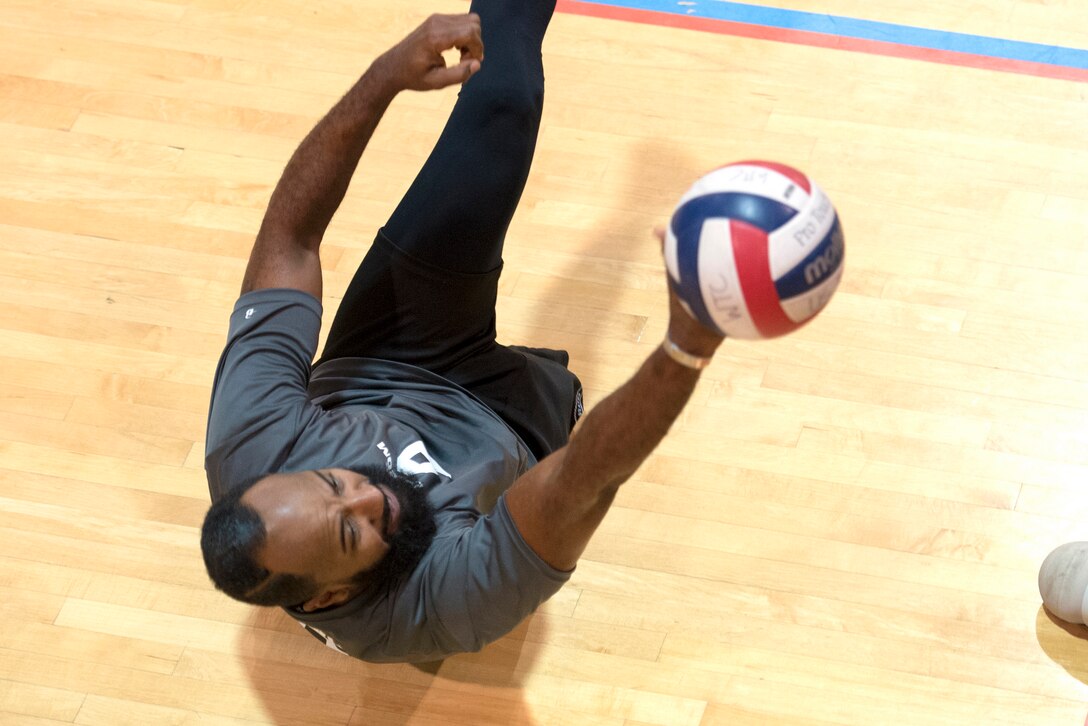 Special Operations Command veteran Alfredo Des Los Santos stops a ball from touching the floor during a joint service sitting volleyball tournament at the Pentagon, Nov. 19, 2015. DoD photo by EJ Hersom