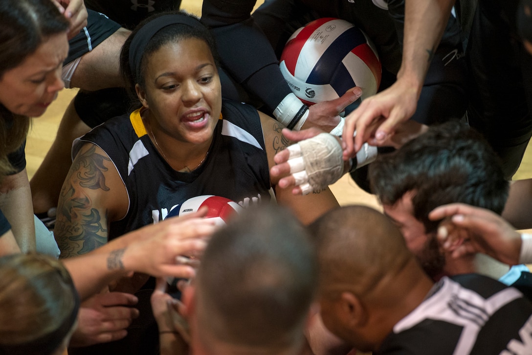 Army veteran Stephanie Morris cheers in a team huddle during a joint service sitting volleyball tournament at the Pentagon, Nov. 19, 2015. DoD photo by EJ Hersom