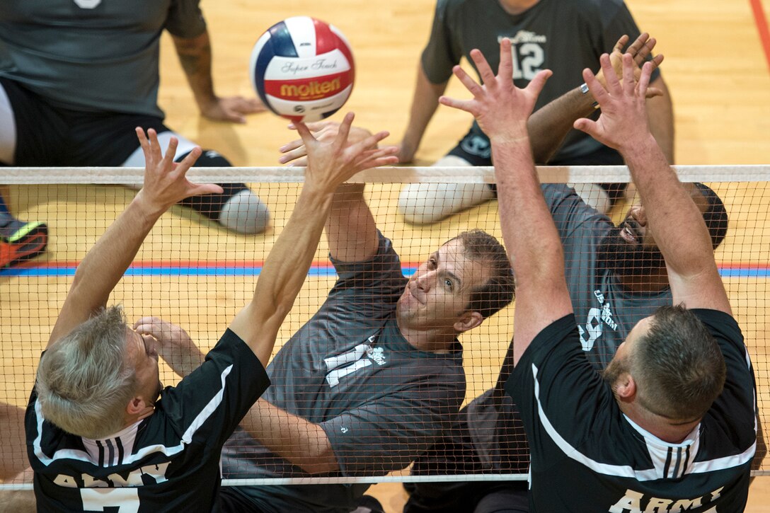 Special Operations Command veteran Yancy Taylor spikes a ball during a joint service sitting volleyball tournament, Nov. 19, 2015. DoD photo by EJ Hersom