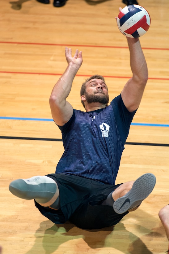 Navy veteran Max Rohn leans back to keep a volleyball in play during a joint service sitting volleyball tournament at the Pentagon, Nov. 19, 2015. DoD photo by EJ Hersom