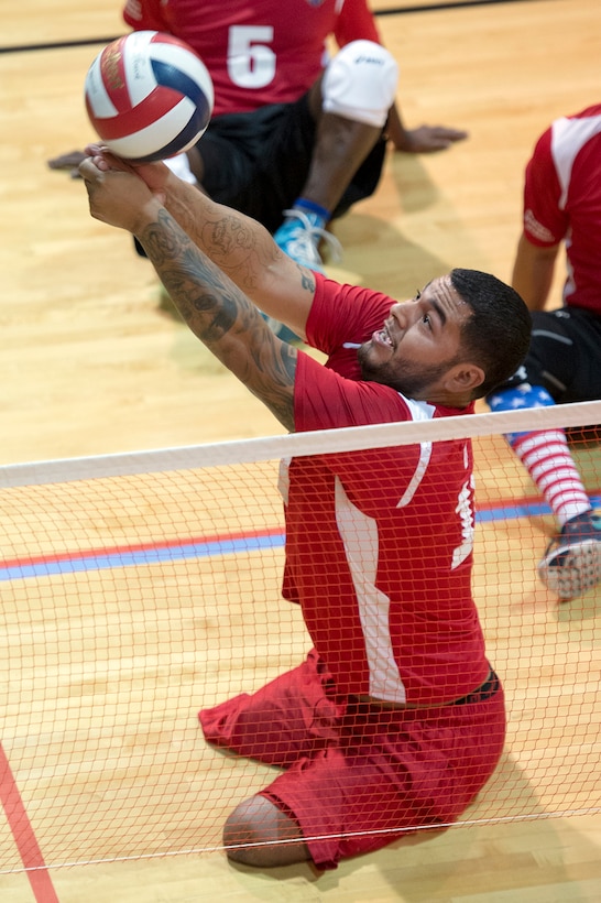 Marine Corps veteran Jorge Salazar bumps a volleyball during a joint service sitting volleyball tournament at the Pentagon, Nov. 19, 2015. DoD photo by EJ Hersom