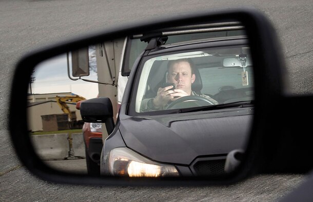 According to Air Force Instruction 91-207, Para. 3.2.1., vehicle operators shall give their full attention to the operation of the vehicle. All drivers must comply with applicable federal, state and local laws that are more stringent than this guidance regarding distractions while driving (e.g., using cellular phones, text messaging). Each base in Pacific Air Forces has policies in place for the use of cell phones while driving, and military members and their families should be familiar with these policies. (U.S. Air Force photo by Justin Connaher/Released )
