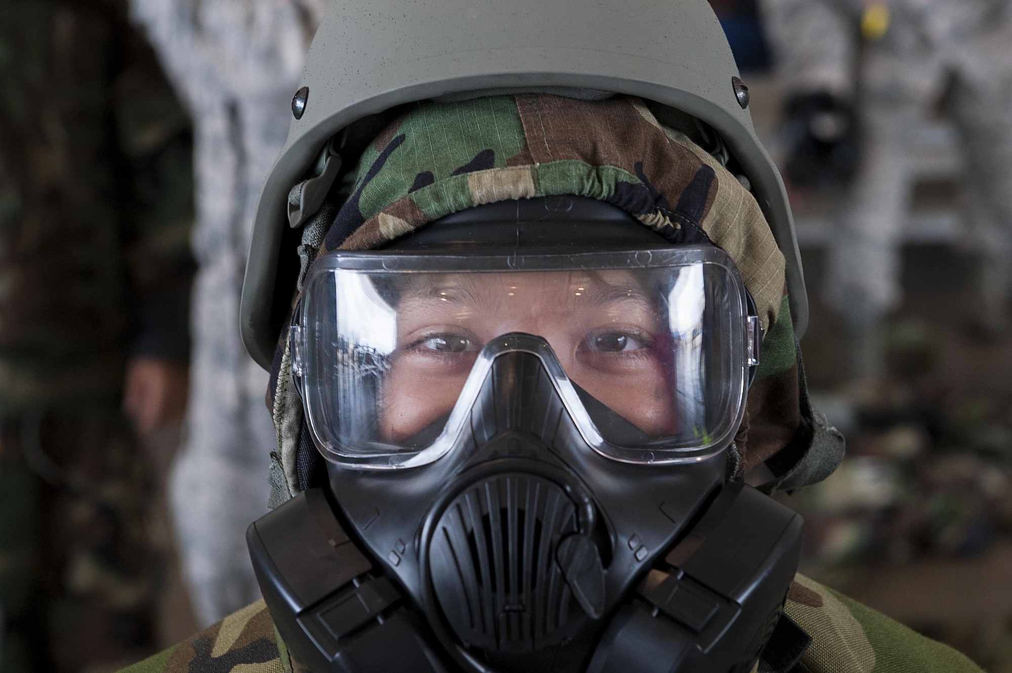 A child tries on a gas mask and mission oriented protective posture (MOPP) gear at Skoshi Warrior Nov. 14, 2015, at Kadena Air Base, Japan. Skoshi Warrior is an annual event designed to help children understand some of the deplyment processes that their military parents go through. (U.S. Air Force photo by Airman 1st Class Corey M. Pettis/Released)