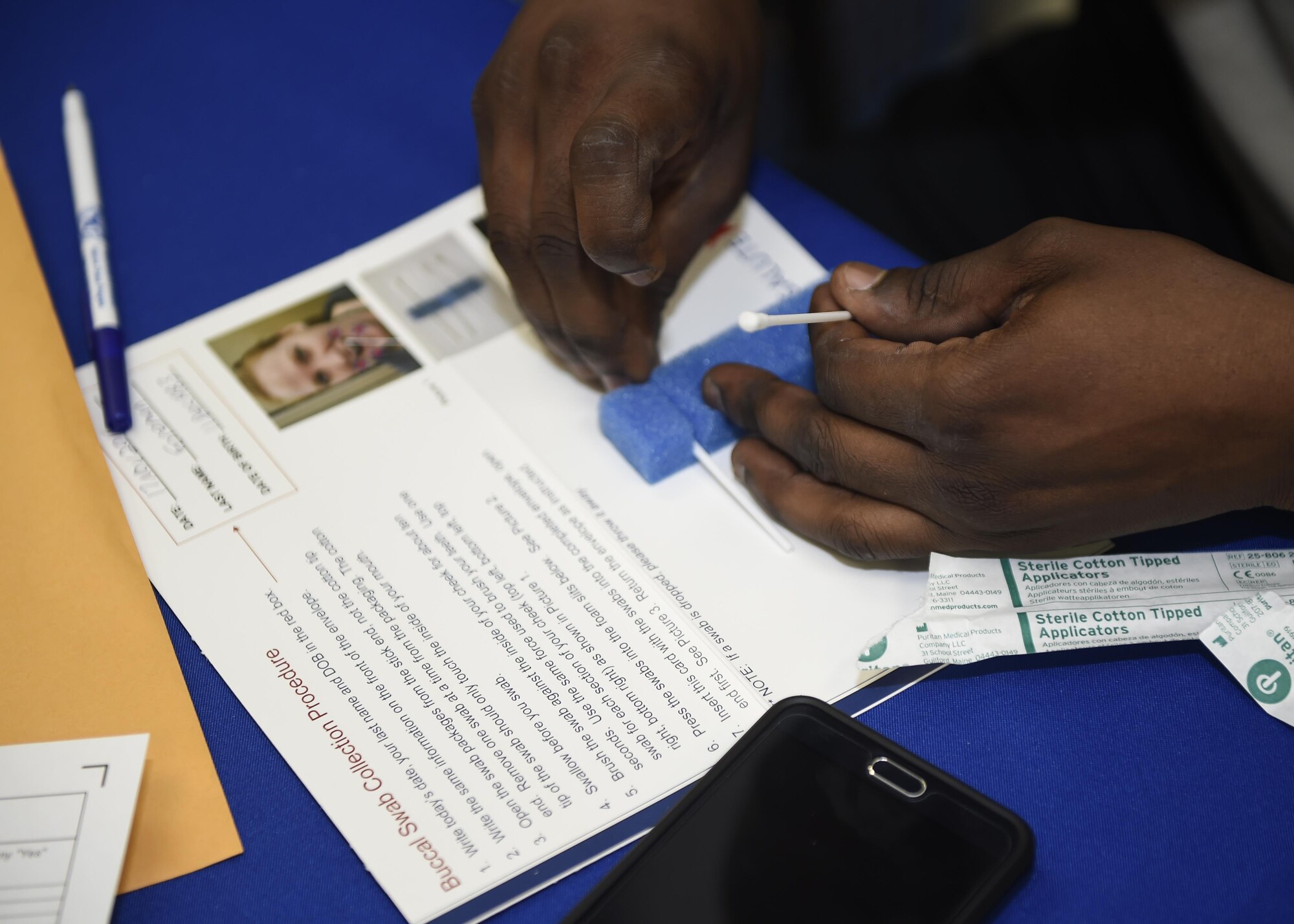 Staff Sgt. Joshua Foreman, an aircrew flight equipment technician with the Special Tactics Training Squadron, places his mouth swab into a package for compatibility testing at Hurlburt Field, Fla., Nov. 17, 2015. The DNA from the mouth swabs collected from Department of Defense members during the bone marrow dinner drive will be added to the National Marrow Donor program records. (U.S. Air Force photo by Airman Kai White)