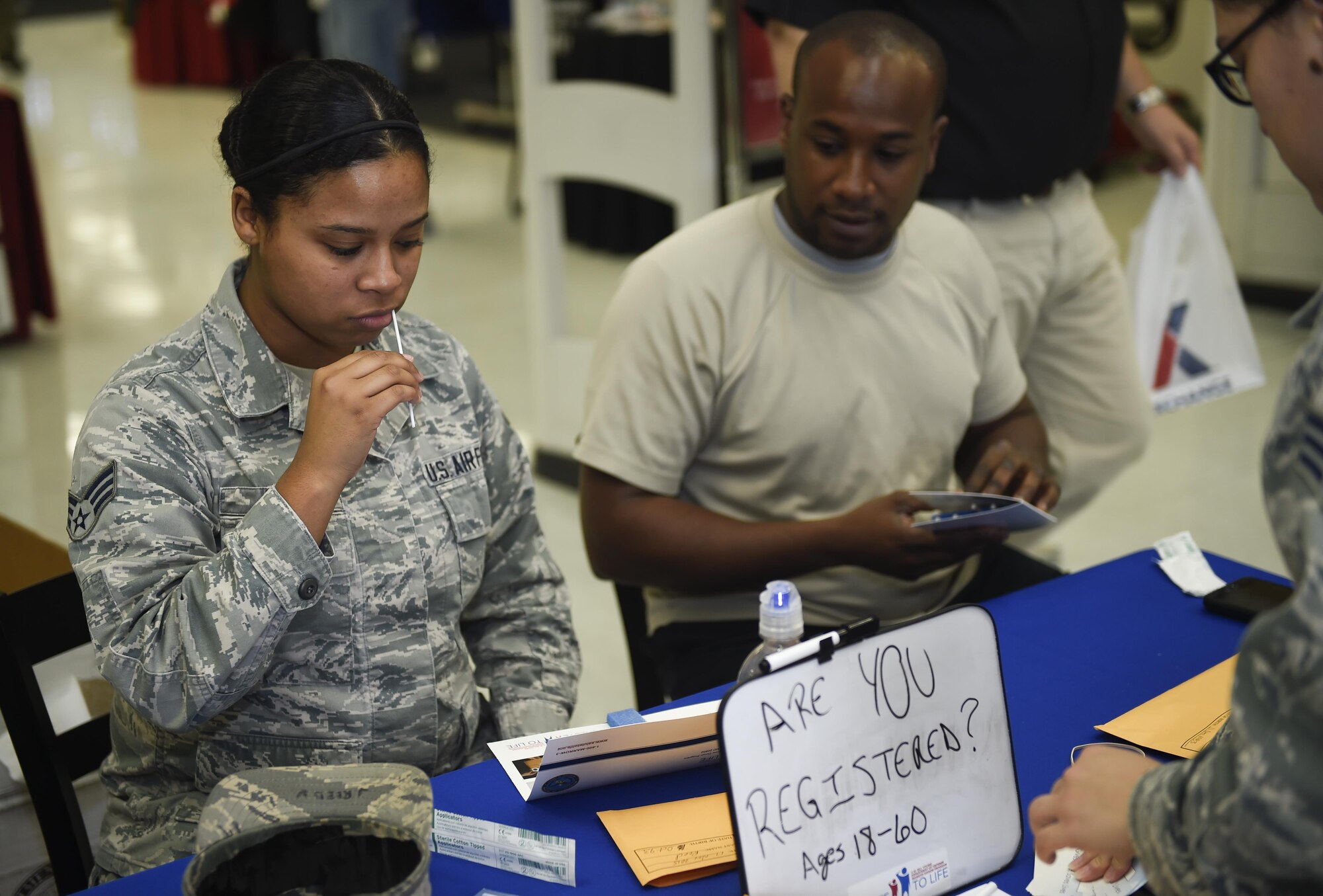 Senior Airman Gabreanna Reed, a cyber surety craftsman with the 1st Special Operations Wing Communications Squadron, and Staff Sgt. Joshua Foreman, an aircrew flight equipment technician with the Special Tactics Training Squadron, provide mouth swabs as potential bone marrow donors at Hurlburt Field, Fla., Nov. 17, 2015. The DNA from the mouth swabs collected from Department of Defense members will be added to the National Marrow Donor program records. (U.S. Air Force photo by Airman Kai White)