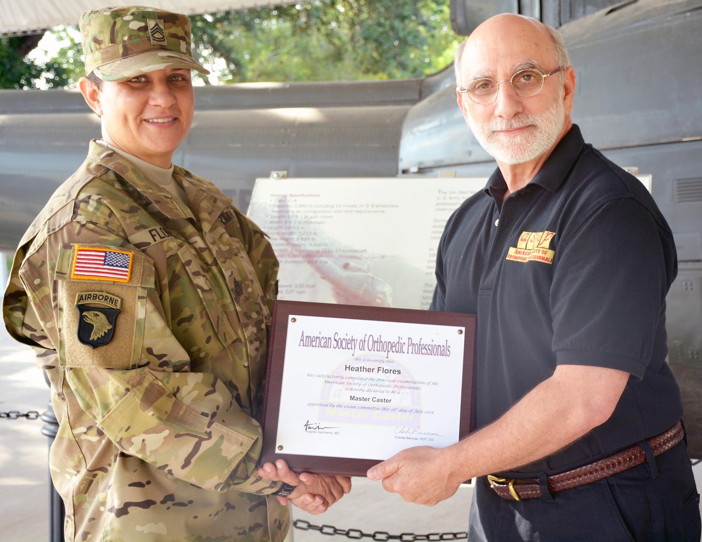 Sgt. 1st Class Heather Flores (left), U.S. Army Medical Command, is presented the  American Society of Orthopedic Professionals Master Caster Certificate by society president Charles Barocas at the U.S. Army Medical Department Museum on Fort Sam Houston.