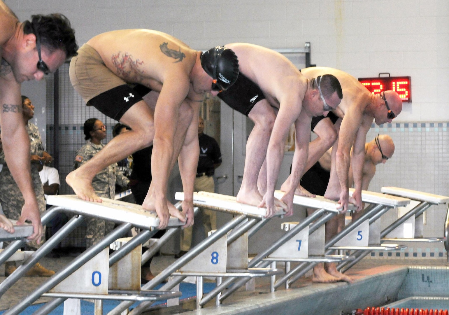 Swimmers take their places on the starting block during the 200-meter swim event of Fort Sam  Houston’s Modern Military Pentathlon at the Jimmy Bought Fitness Center Nov. 6. More than 20 swimmers from the Army, Navy, and Marines participated in the event.