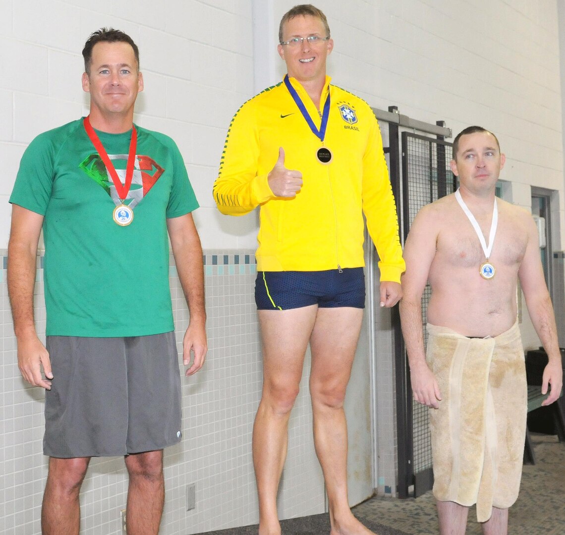 The medal for top swimmer went to Navy Lt. Correy Dean (center). Second place went to Army Maj. Tim Hansen (left) of Army North Task Force 51, while the third-place medal went to Sgt. 1st Class Thomas Lucas of the NCO Academy Brigade (right).