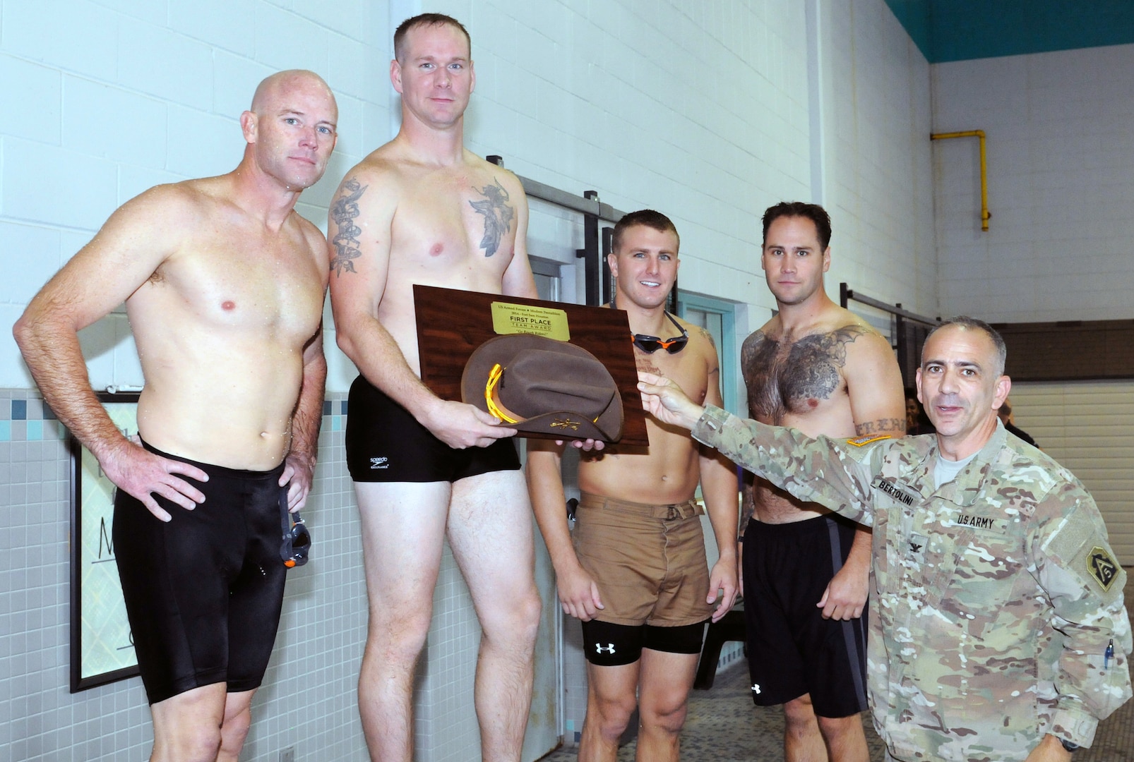 Marines from the 4th Reconnaissance Battalion placed as the top team at Friday’s 200-meter swim event of Fort Sam Houston’s Modern Military Pentathlon, receiving their award from U.S. Army North chief of staff  Col. Mark A Bertolini at the Jimmy Bought Fitness Center Nov. 6. Team members included (from left) Lt. Col. Eric Dill, Staff Sgt. Joey McDonald, Sgt. Dustin Jones and Sgt. Robert Bagley.