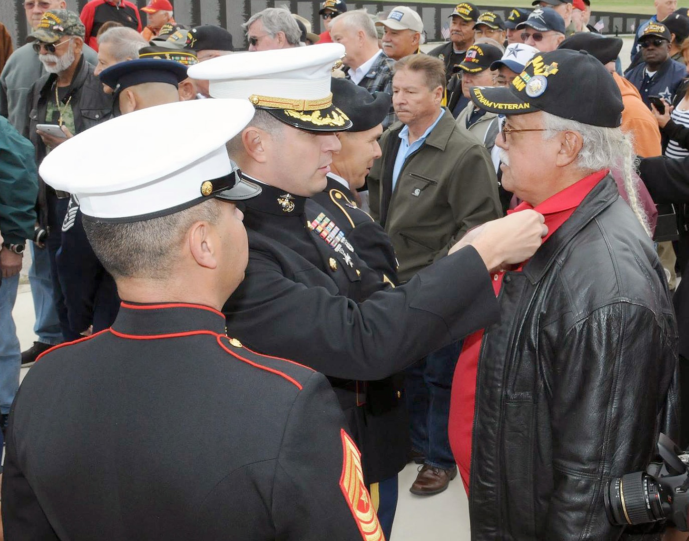 U.S. Marine Corps Maj. Oscar Rodriguez, commander of the 4th Reconnaissance Battalion at Fort Sam Houston and Command Sgt. Maj. Mark Gonzales, pin the Vietnam Veteran Lapel Pin on USMC Vietnam veterans during the “Salute To Veterans” event at MacArthur Field on Fort Sam Houston Friday, which honored veterans past and present for their service.