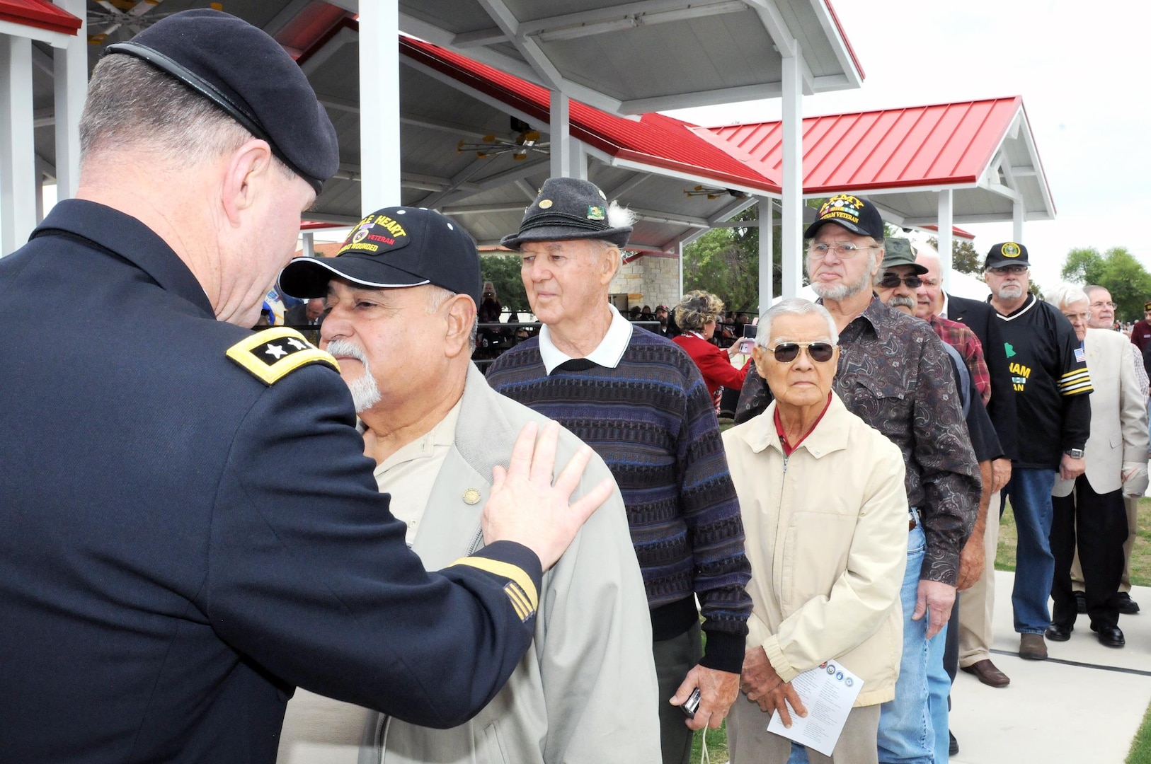 Lt. Gen. Perry L. Wiggins (left) and other senior military leaders from around Fort Sam Houston and Joint Base San Antonio gave special recognition to Vietnam Veterans in attendance by presenting each with a lapel pin for their service during the “Salute To Veterans” event at MacArthur Field on Fort Sam Houston Friday, honoring veterans past and present for their service. Wiggins is the commanding general of U.S. Army North (Fifth Army) and senior Army commander of Fort Sam Houston and Camp Bullis.