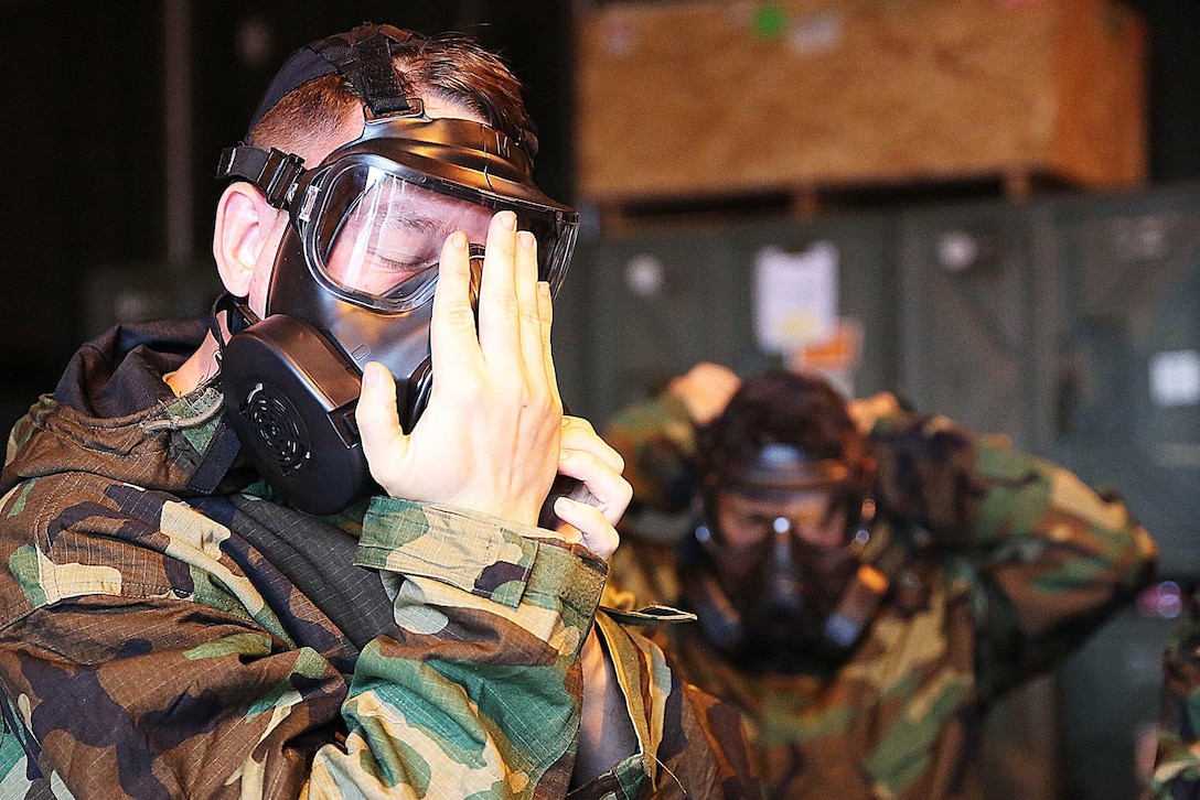 A U.S. Marine practices protecting his air supply during a simulated chemical attack on Marine Corps Air Station Iwakuni, Japan, Nov. 18, 2015.