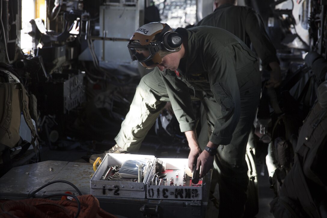 Lance Cpl. Christopher Pickens, a crew chief with Marine Heavy Helicopter Squadron (HMH) 465 “Warhorse” and an Irvine, Calif. native, puts away tools prior to a training flight aboard Marine Corps Air Station Miramar, Calif., Nov. 16. Marines with HMH-465 will conduct aerial gun shoots, fire bucket training and terrain flights over the course of five days in El Centro, Calif. (U.S. Marine Corps photo by Sgt. Lillian Stephens/Released)