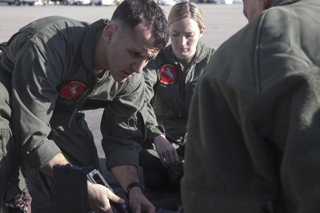 Marines with Marine Heavy Helicopter Squadron 465 “Warhorse,” disassemble a .50-caliber machine gun aboard Marine Corps Air Station Miramar, Calif., Nov. 16. Marines with HMH-465 will conduct aerial gun shoots, fire bucket training and terrain flights over the course of five days in El Centro, Calif. (U.S. Marine Corps photo by Sgt. Lillian Stephens/Released)