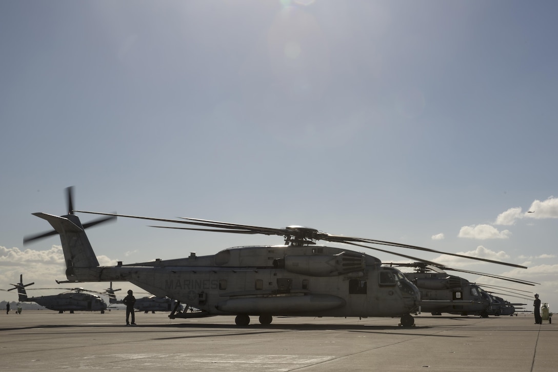 Crew members with Marine Heavy Helicopter Squadron (HMH) 465 “Warhorse” prepare a CH-53E Super Stallion for flight aboard Marine Corps Air Station Miramar, Calif., Nov. 16. Marines with HMH-465 will conduct aerial gun shoots, fire bucket training and terrain flights over the course of five days in El Centro, Calif. (U.S. Marine Corps photo by Sgt. Lillian Stephens/Released)