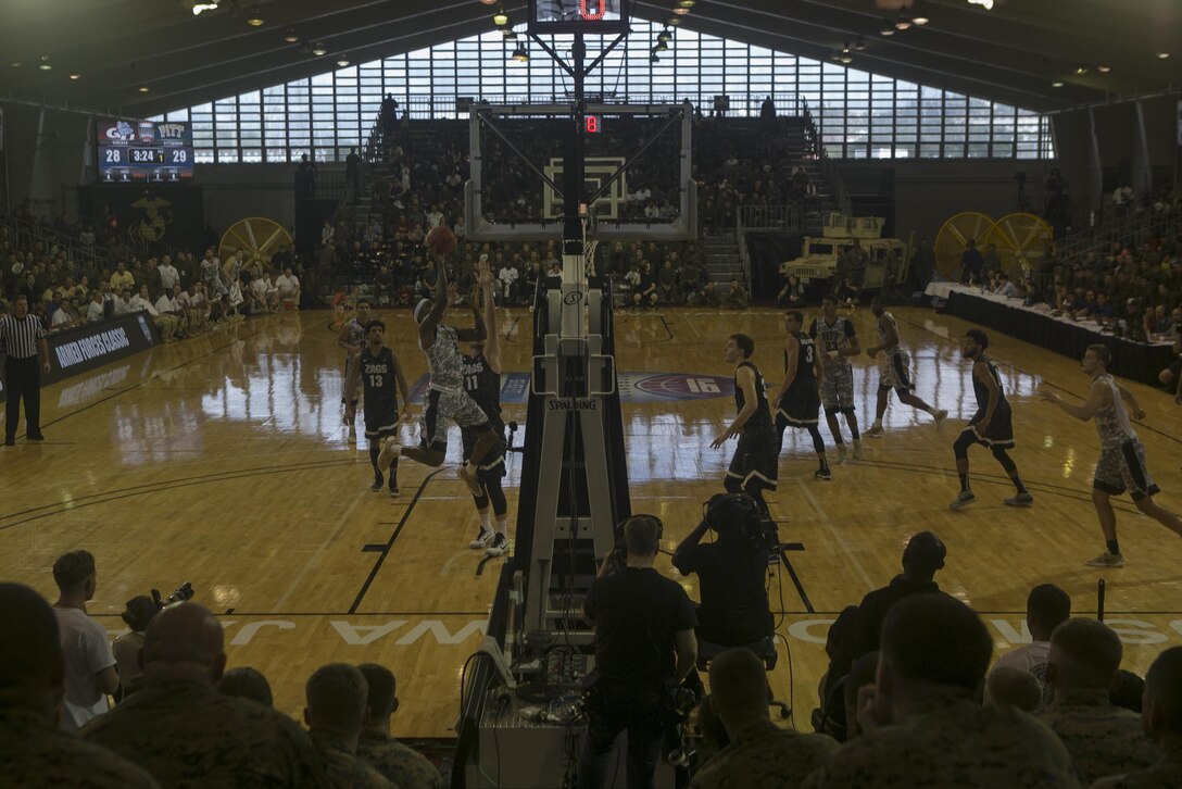 The Gonzaga Bulldogs and the Pittsburg Panthers battle for a basket during the 2015 Armed Forces Classic Nov. 14 at the Foster Fieldhouse aboard Camp Foster, Okinawa, Japan. This marked the fourth year the Armed Forces Classic was held and the second time it was played in East Asia. The two teams battled in a heated, back and fourth game with Pitt leading 37-35 after twenty minutes of game time until the game was called off due to slippery playing conditions.