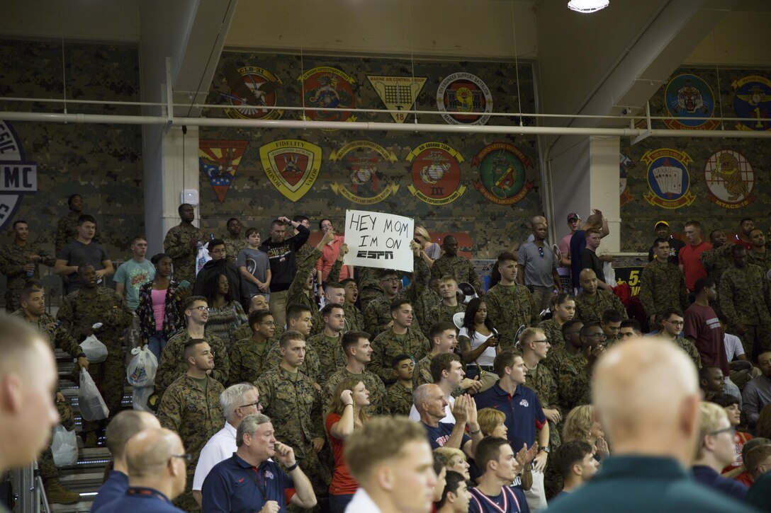 Pfc. Francisco Barajas sends a message to his mother during the 2015 Armed Forces Classic Nov. 14 at the Foster Fieldhouse aboard Camp Foster, Okinawa, Japan. This marked the fourth year the Armed Forces Classic was held and the second time it was played in East Asia. The two teams battled in a heated, back and fourth game with Pitt leading 37-35 after twenty minutes of game time until the game was called off due to slippery playing conditions. Barajas, an Underwood, Iowa, native, is an automotive maintenance technician with 3rd Maintenance Battalion, Combat Logistics Regiment 35, 3rd Marine Logistics Group, III Marine Expeditionary Force.