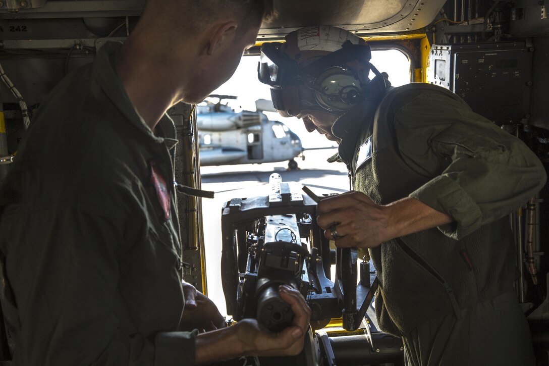 Marines with Marine Heavy Helicopter Squadron 465 “Warhorse” mount a .50-caliber machine gun onto a CH-53E Super Stallion aboard Marine Corps Air Station Miramar, California, Nov. 16, 2015. Marines with HMH-465 will conduct aerial gun shoots, fire bucket training and terrain flights over the course of five days in El Centro, California. 