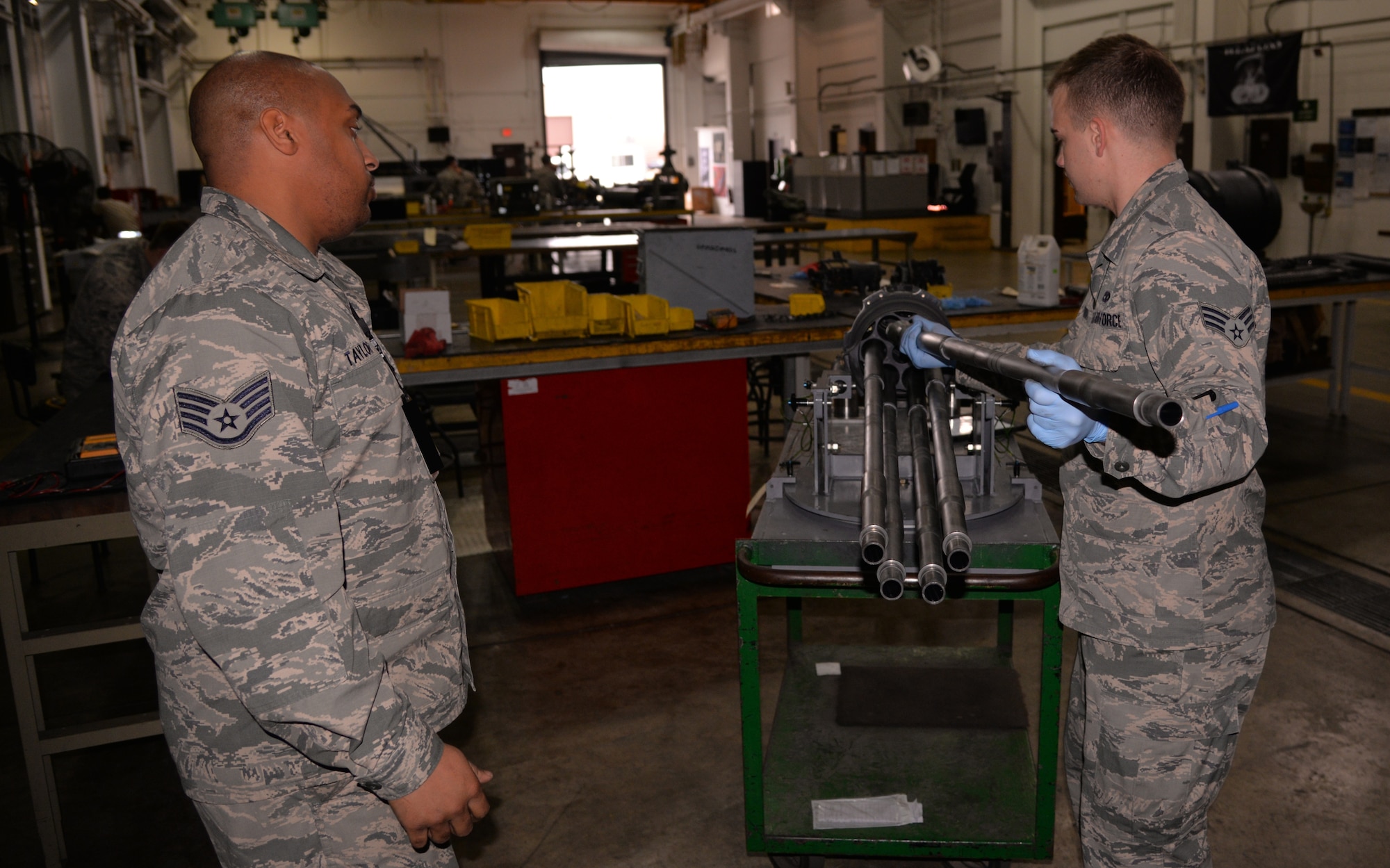 Staff Sgt. Robert Taylor, 51st Munitions Squadron F-16 armament floor chief, and Senior Airman Jacob Brown, 51st MUNS aircraft armament systems journeyman, put a 20-mm gun for an F-16 Fighting Falcon back together after performing maintenance Nov. 18, 2015, at Osan Air Base, Republic of Korea. These maintainers from the 51st MUNS armament flight keep the F-16 Fighting Falcon weapon systems operational both day and night. (U.S. Air Force photo/Staff Sgt. Benjamin Sutton) (Editor's note: A part of this image was blacked out for operational security reasons.)