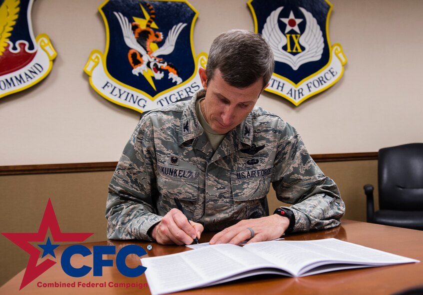 U.S. Air Force Col. Thomas Kunkel, 23d Wing commander, signs a donation form for the Combined Federal Campaign, Nov. 19, 2015 at Moody Air Force Base, Ga. The CFC runs from Sept. 1 to Dec. 15, 2015 and is a way for service members to give back to the community through different charities. Contact your unit CFC representative in order to give or for more information. (U.S. Air Force illustration/Tech. Sgt. Zachary Wolf)