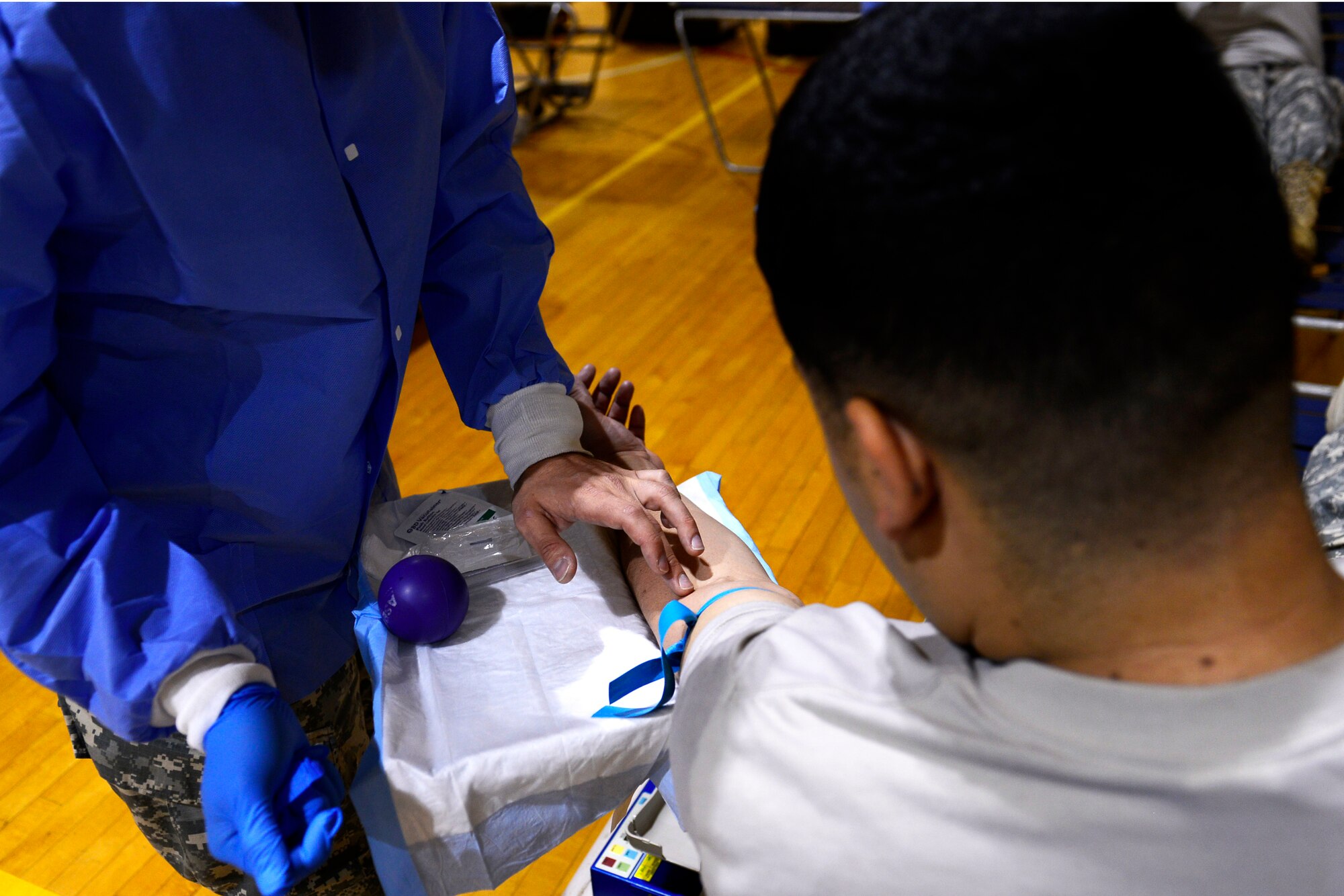 U.S. Army Spc. Eric Gallego, Dwight D. Eisenhower Army Medical Center Bravo Company lab specialist, prepares to have blood extracted during an Armed Services Blood Program blood drive at Shaw Air Force Base, S.C., Nov. 18, 2015. The ASBP collects blood from around the globe to treat personnel with illnesses and injuries acquired in battlefields and natural disasters. (U.S. Air Force photo by Airman 1st Class Christopher Maldonado)