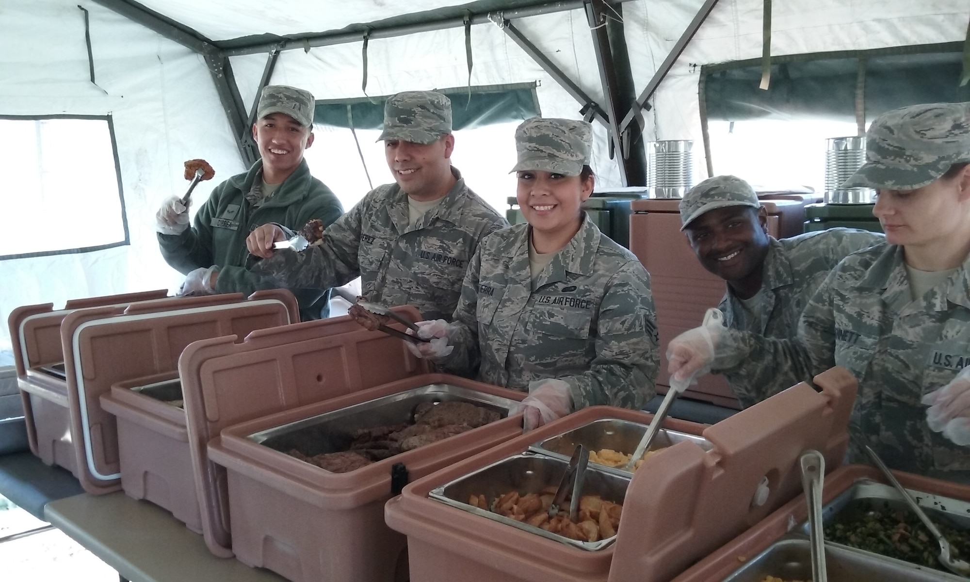 Airmen from the 507th Air Refueling Wing Force Support Squadron Services Sustainment Flight prepare to serve food during a field kitchen training exercise Nov. 7, 2015, at Tinker Air Force Base, Okla. The field kitchen is an Air Force requirement for use at remote and undeveloped sites.  (U.S. Air Force photo by Senior Airman Chelsea Thomas) 