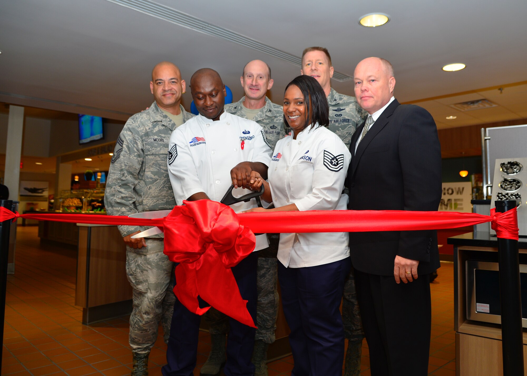 From left to right, back to front, Chief Master Sgt. Geraldo Moore, 436th Airlift Wing acting command chief; Col. Marc Piccolo, Air Force Services Activity commander; Col. Michael Grismer, 436th AW commander; Tech. Sgt. Mark Obeng Duro, 436th Force Support Squadron food service section chief; Tech. Sgt. Rhoneiula Johnson, 436th FSS dining facility manager and Brett Ladd, Sodexo senior vice president; cut the ribbon during the grand reopening of the Patterson Dining Facility Nov. 19, 2015, at Dover Air Force Base, Del. The dining facility underwent renovations and improvements from the Air Force Food Transformation Initiative to offer a wider variety of nutritional foods and beverages. (U.S. Air Force photo/Senior Airman William Johnson)
