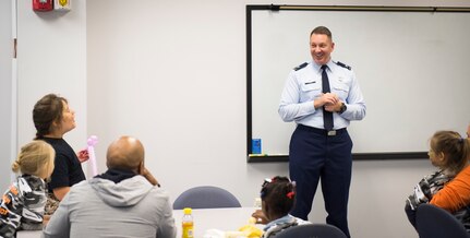 Col. Robert Lyman, Joint Base Charleston commander, talks with children participating in a mock deployment line event November 14, 2015, in a classroom at the 628th Logistics Readiness Squadron on JB Charleston – Air Base, S.C. The event was held to give children a glimpse into what it’s like for their parents to prepare for a deployment. During the event, children transitioned through a mock processing line where they spoke to several base agencies including the chapel, medical, finance, Airman and Family Readiness Center, base leadership and more. (U.S. Air Force photo/Airman 1st Class Clayton Cupit)