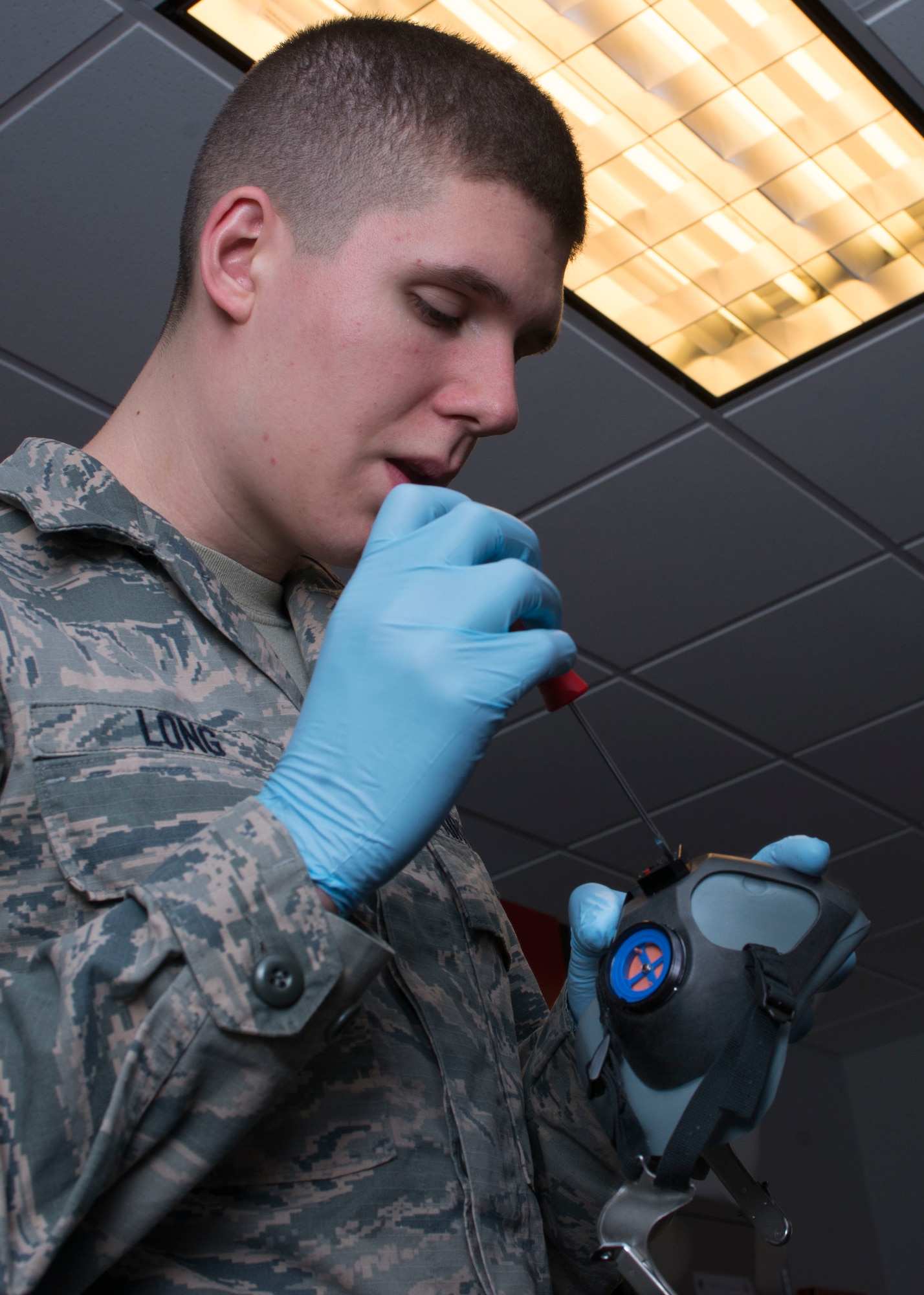 U.S. Air Force Senior Airman Patrick Long, an Aircrew Flight Equipment (AFE) journeymen assigned to the 1st Operation Support Squadron, disassembles a MBU-20/P Oxygen Mask for a 30-day inspection at Langley Air Force Base, Va., Nov. 17, 2015.  The AFE personnel use various types of equipment such as altimeters, oxygen testers, leakage testers and radio testers to conduct reliability tests. (U.S. Air Force photo by Staff Sgt. J.D. Strong II)