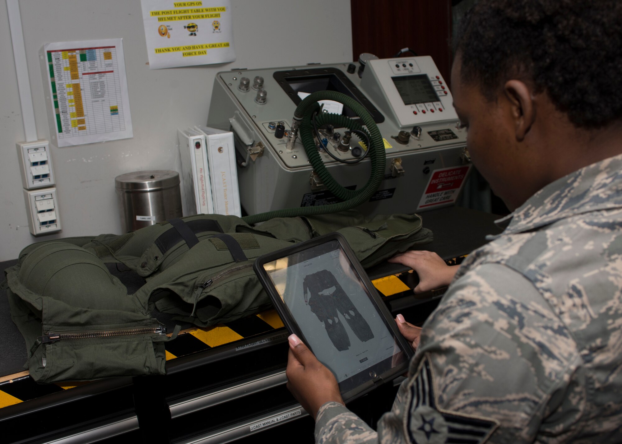 U.S. Air Force Staff Sgt. Deandrea Boone, an Aircrew Flight Equipment (AFE) craftsmen assigned to the 192nd Operation Support Squadron, examines a CSU-13B/P Anti-G Suit for leaks at Langley Air Force Base, Va., Nov. 17, 2015. The AFE personnel issue, fit, repair and maintain flight equipment such as parachutes, helmets and oxygen equipment. (U.S. Air Force photo by Staff Sgt. J.D. Strong II)