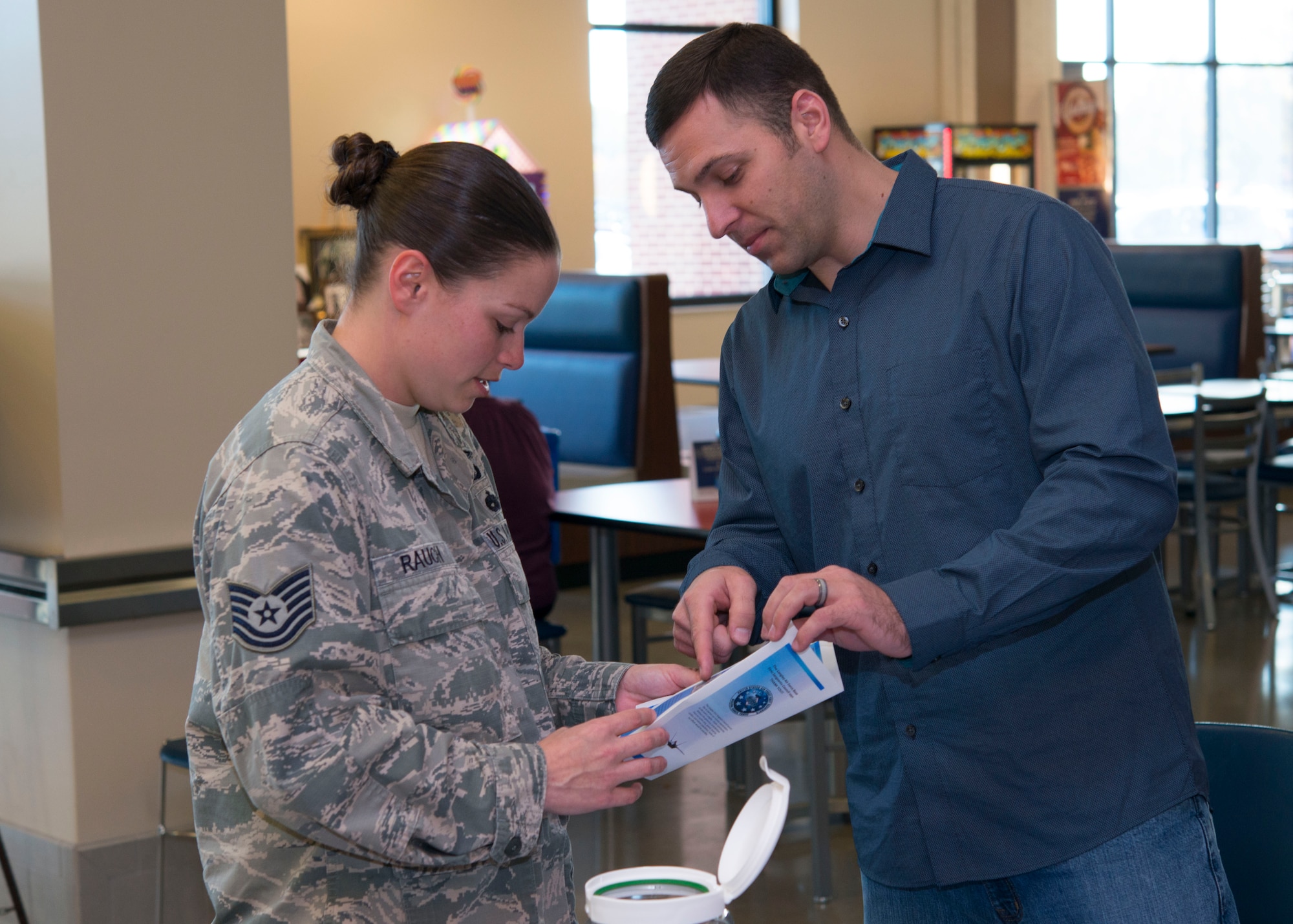 U.S. Air Force Tech. Sgt. Andrew, a security manager assigned to the 497th Operation Support Squadron, explains Operation Warmheart to Tech. Sgt. Rauch, a special programs manager assigned to the 480th Intelligence Surveillance and Reconnaissance Wing, at the Exchange at Langley Air Force Base, Va., Nov. 16, 2015. The Langley First Sergeant Council hosts the Operation Warmheart Thanksgiving Basket Drive annually, to assist Joint Base Langley-Eustis families.
(U.S. Air Force photo by Staff Sgt. J.D. Strong II)
