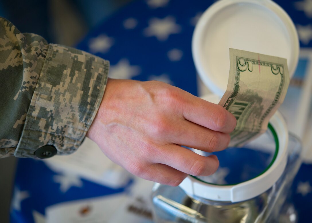 U.S. Air Force Tech. Sgt. Kacey, a special programs manager assigned to the 480th Intelligence Surveillance and Reconnaissance Wing, donates to the Operation Warmheart Thanksgiving Basket Drive at the Exchange at Langley Air Force Base, Va., Nov. 16, 2015. Operation Warmheart is a nonprofit organization established to receive, manage and distribute charitable funds to Joint Base Langley-Eustis families. (U.S. Air Force photo by Staff Sgt. J.D. Strong II)