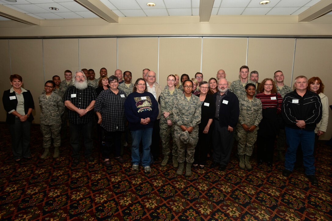 U.S. Airmen and families from the Hampton Roads, Va., region meet for the first time during the “Adopt an Airman” program reception at Langley Air Force Base, Va., Nov. 16, 2015. The program aims to strengthen the bond between the military and the Hampton Roads communities, pairing first-term Airmen with local families, giving Airmen an avenue to form new friendships and gather support from the community. (U.S. Air Force photo by Staff Sgt. Ciara Gosier)
