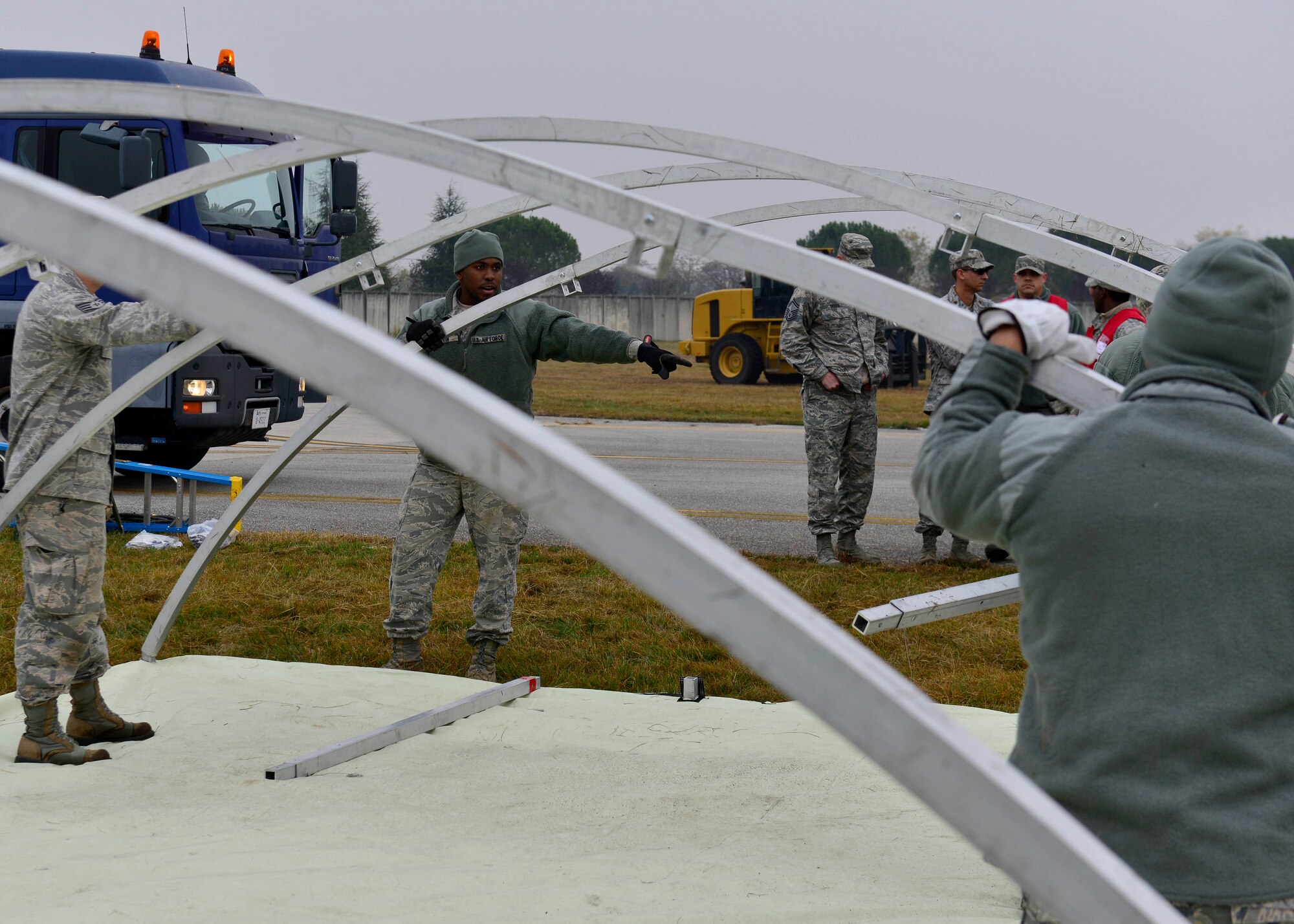 U.S. Air Force Airmen from the 31st Fighter Wing construct a tent during a wing inspection, Nov. 17, 2015, at Aviano Air Base, Italy. The 31st Fighter Wing conducts in several inspections annually designed to identify and rectify deficiencies while highlighting best practices and outstanding performers. (U.S. Air Force photo by Airman 1st Class Cary Smith/Released)
