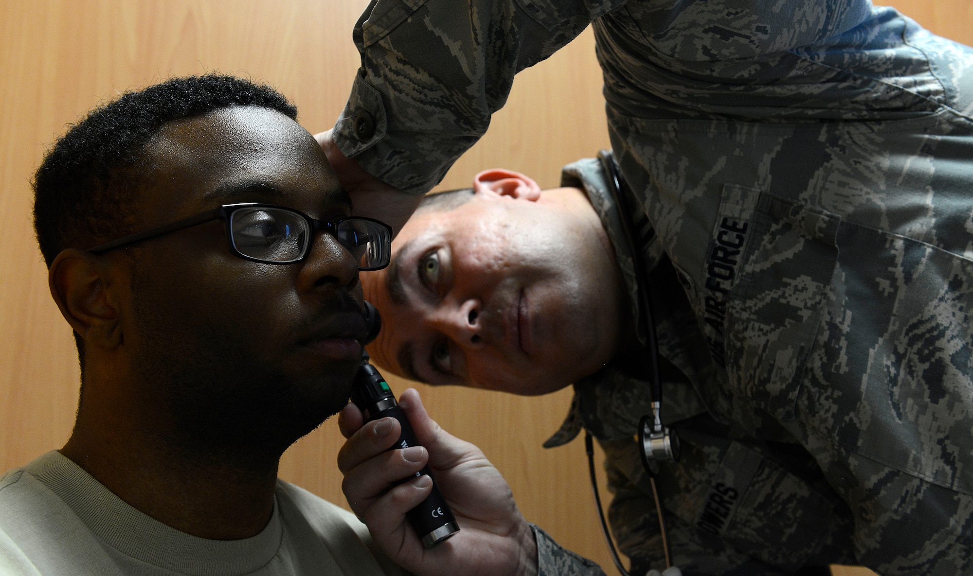 Capt. Foye Flowers, Family Health Clinic clinical nurse, looks in the ear of Senior Airman Markeith Davis, 1st Combat Communications radio frequencies transmission technician, at the Cold and Allergy Clinic at Ramstein Air Base, Germany, Nov. 4, 2015. The new clinic was opened to help relieve the increased volume of patients coming to the Family Health Clinic who are suffering from symptoms associated with common ailments during the winter and spring seasons. (U.S. Air Force photo/Airman 1st Class Tryphena Mayhugh)