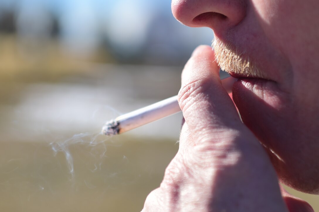 An Airman smokes a cigarette in a designated area Nov. 19, 2015, at Buckley Air Force Base, Colo.  The Great American Smokeout is held every year in November and is an initiative by the American Cancer Society to get people to stop smoking. According to the American Cancer Society, the day is set aside to encourage smokers to go the distance, and finally give up smoking. (U.S. Air Force photo by Airman 1st Class Luke W. Nowakowski/Released)