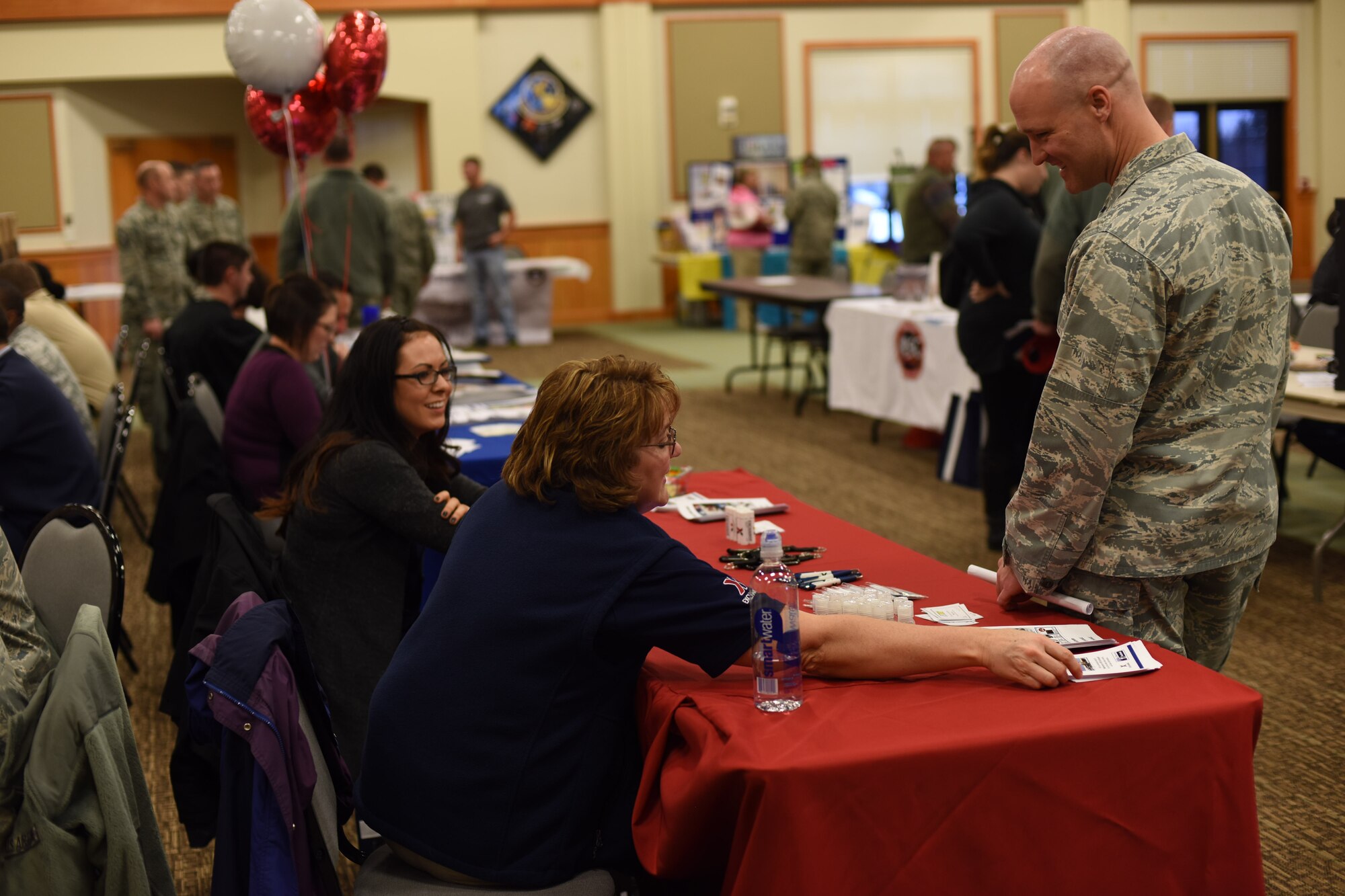 Col. Jay Folds, 341st Missile Wing vice commander, right, speaks with representatives of the Malmstrom Air Force Base Exchange during a base fair held at the Grizzly Bend Nov. 18, 2015. In all, 215 people attended the event. (U.S. Air Force photo/Airman Collin Schmidt) 