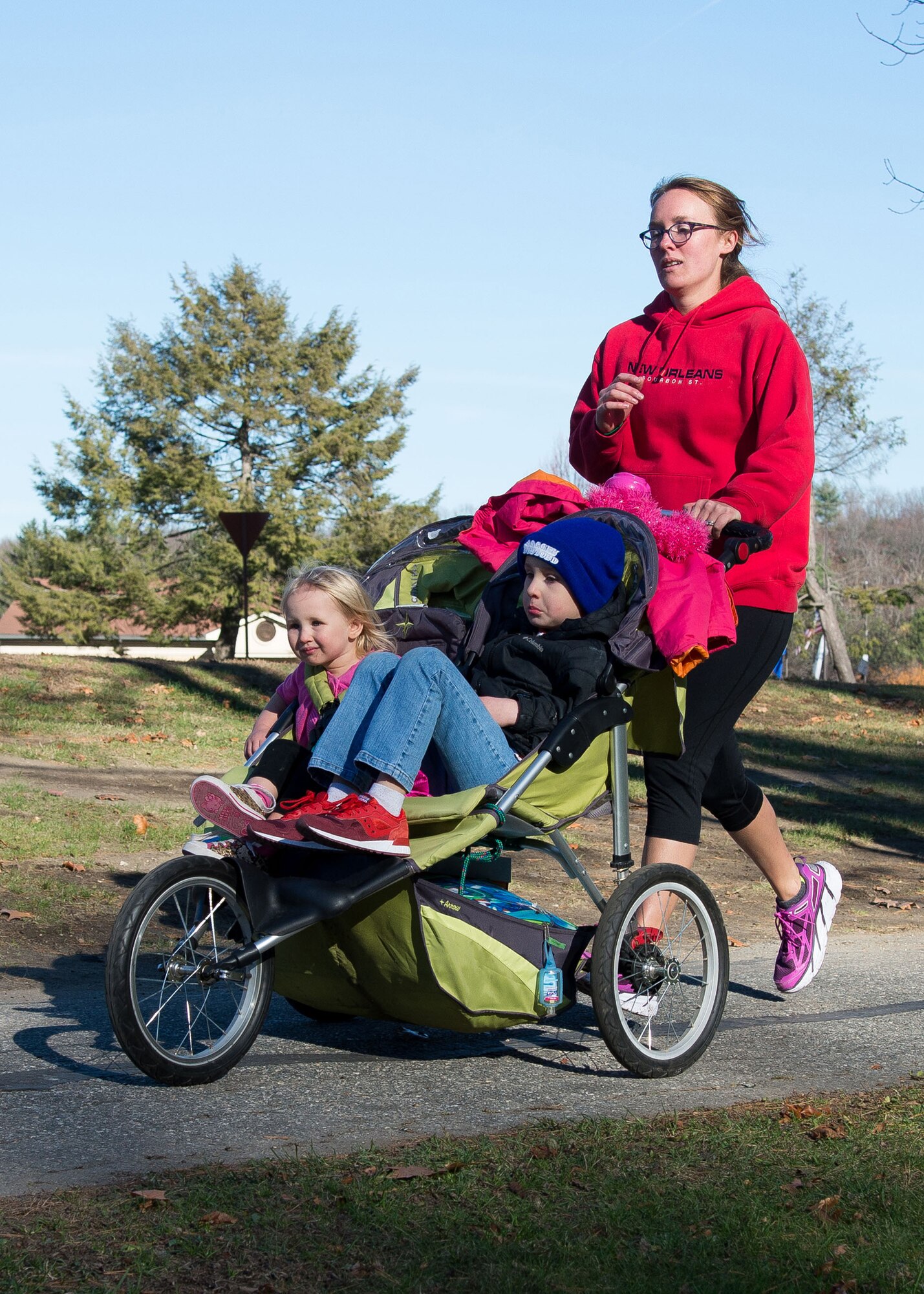 Katy Murray, and her two children, Calvin and Dottie, participate in the Family 2K Fun Run on base Nov. 18. The event was one of several events planned throughout the month in recognition of Month of the Military Family Month that is observed each November. (U.S. Air Force photo by Mark Herlihy)