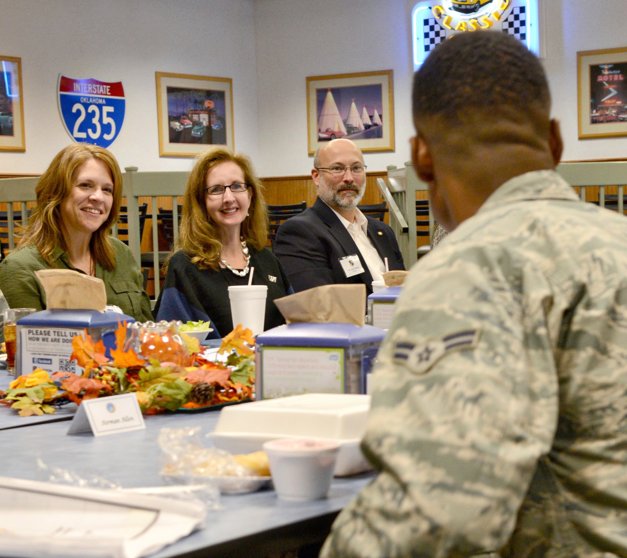 Rhonda Levy, wife of Air Force Sustainment Center Commander Lt. Gen. Lee Levy II, hears from Airman 1st Class Duantonio Allen, from the 72nd Force Support Squadron, during a luncheon with key spouses at the Vanwey Dining Facility during a Nov. 16-17 immersion tour of Tinker. Also on the tour were Debi Stamey, wife of Kevin Stamey, director of the AFSC Engineering Directorate, left, and Scott Wilson, husband of 72nd Air Base Wing Commander Col. Stephanie Wilson. (Air Force photo by Kelly White/Released)