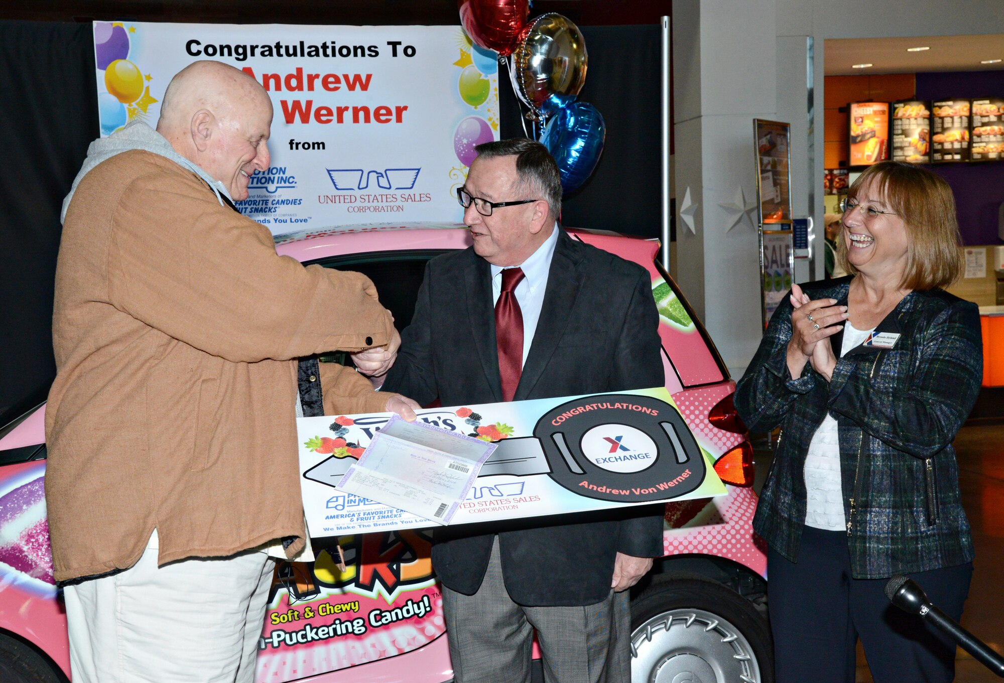 Andrew Von Werner was the winner of a Smart Car giveaway sponsored by the Army and Air Force Exchange Service and Promotion in Motion, the maker of Welch’s Fruit Snacks. During the Nov. 12 ceremony, papers were signed and keys handed over to Mr. Von Werner, a Vietnam veteran and retired Navy petty officer first class, by Jim Finelli, vice president of sales for Promotion in Motion, and Brenda Hyland, Tinker Air Force Base Exchange general manager. Mr. Von Werner’s entry was one of two selected out of more than 11,600 received from Exchange locations around the world. (Air Force photo by Kelly White/Released)