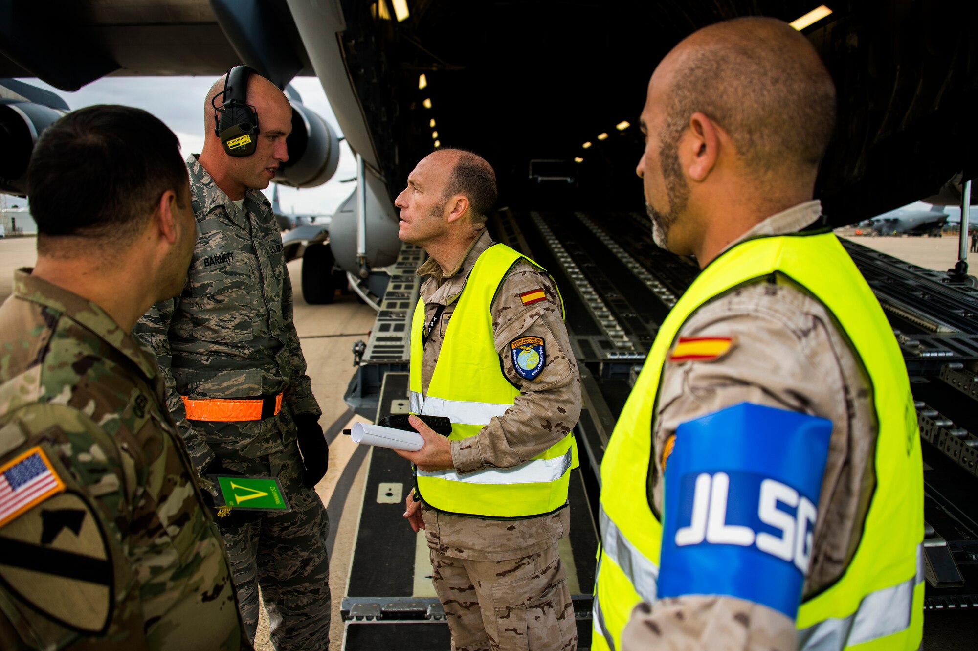 Staff Sgt. Brennec Barnett, an aerial port supervisor for the 921st Contingency Response Squadron from Travis Air Force Base, Calif., coordinates passenger movement with the Spanish Air Force and the 82nd Airborne Division after dropping approximately 600 Paratroopers from the 82nd Airborne Division over Zaragoza, Spain on November 4, 2015 for Exercise Ultimate Reach/ Trident Juncture. (U.S. Air Force Photos by Tech. Sgt. Matthew Hannen)